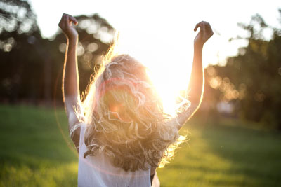 CBD Collection uplifted woman in sunshine